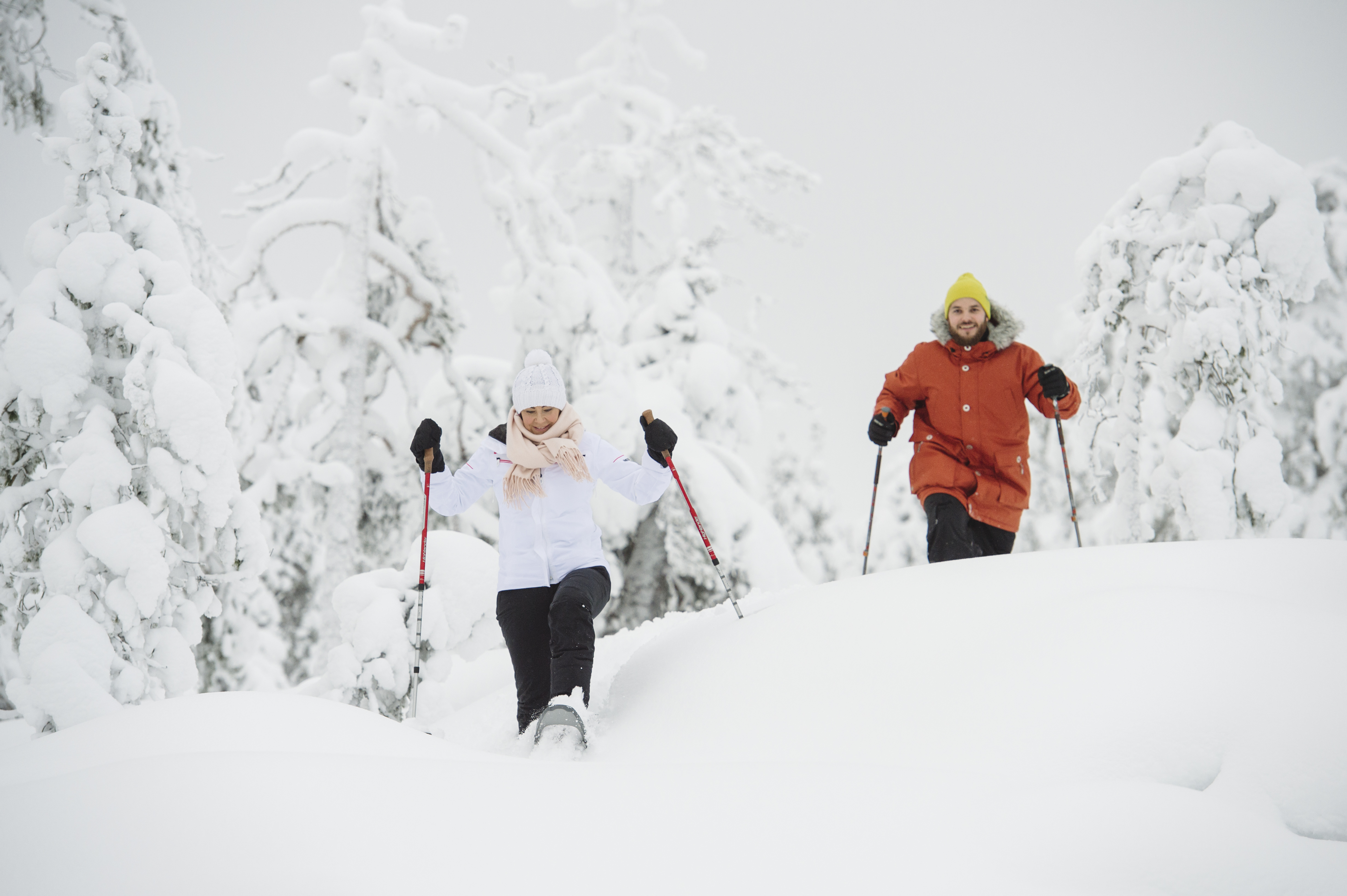 A couple snowshoeing in the forest