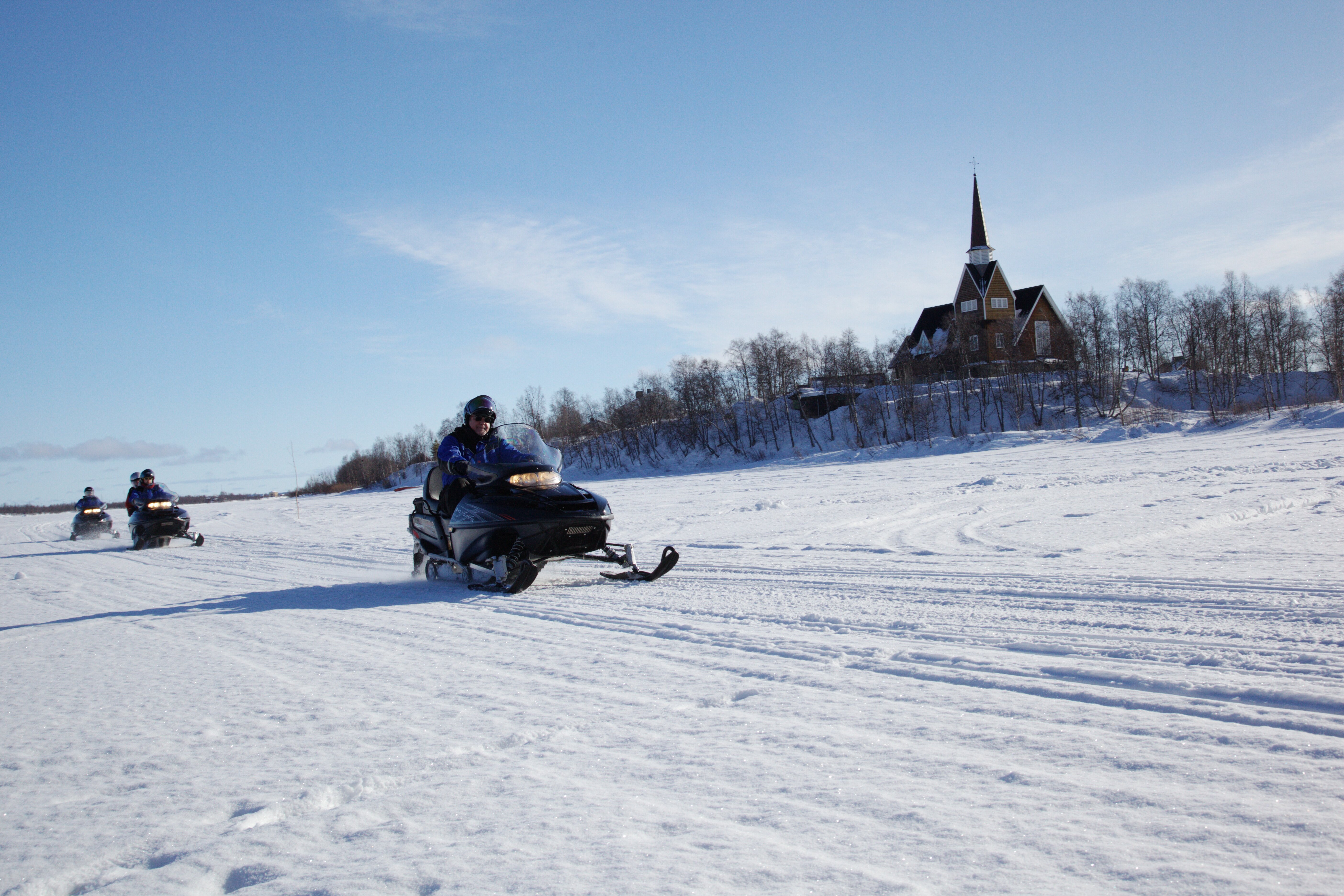 Snowmobilers on frozen Muonionjoki in Karesuando
